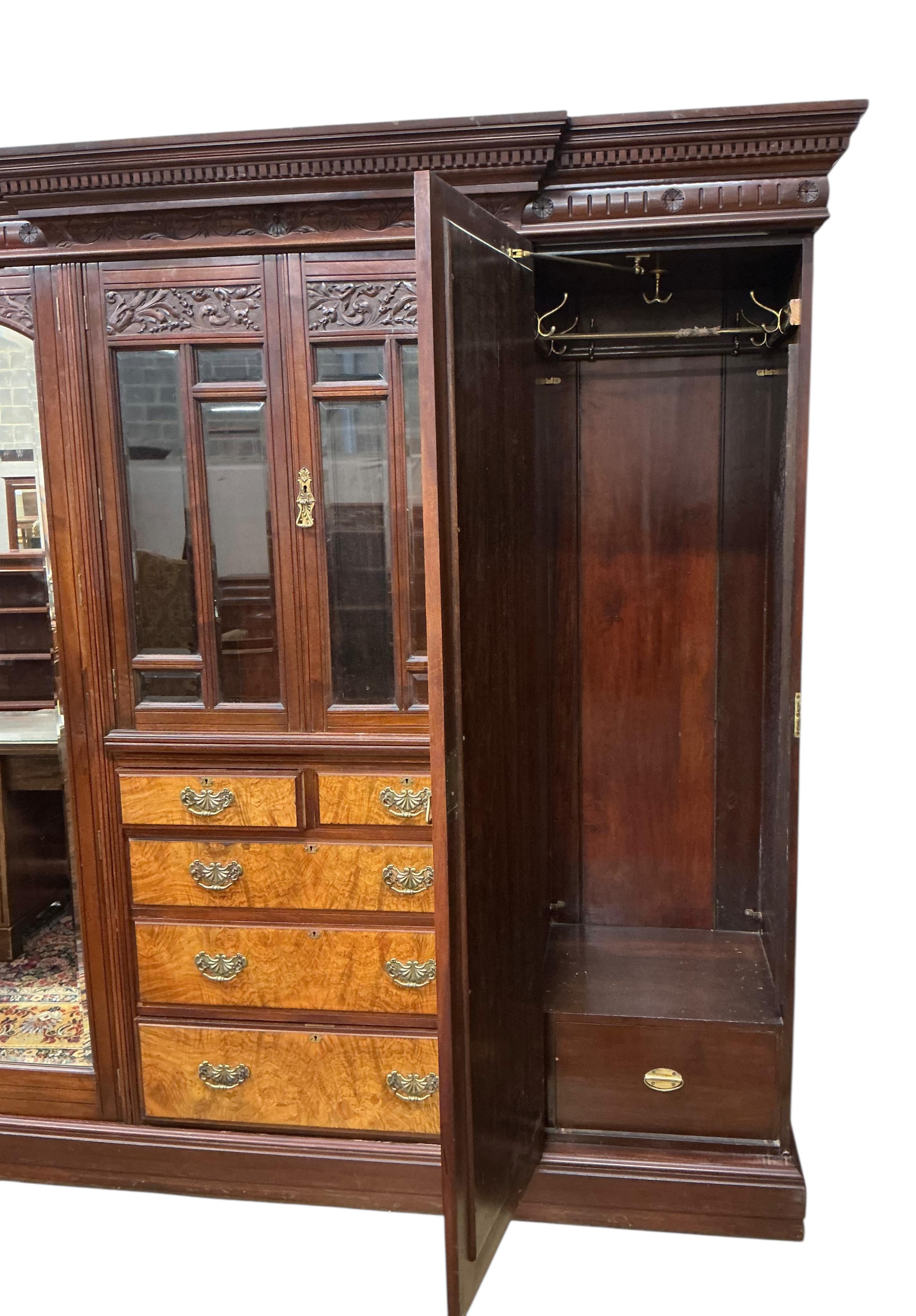 A late Victorian carved mahogany mirrored wardrobe, width 208cm, depth 60cm, height 218cm